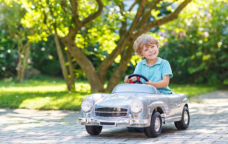 little boy driving big toy