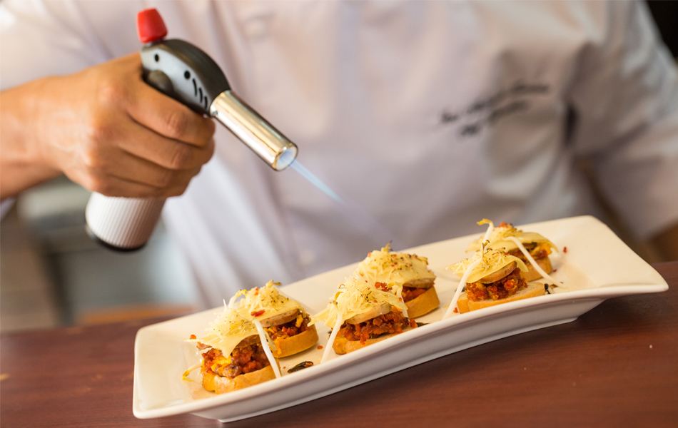 chef using kitchen torch