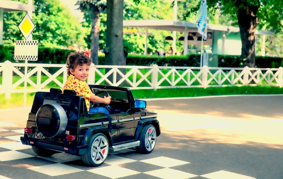 boy driving an electric car for kids