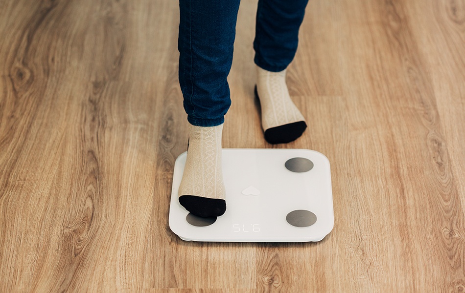 girl measures weight on smart scales