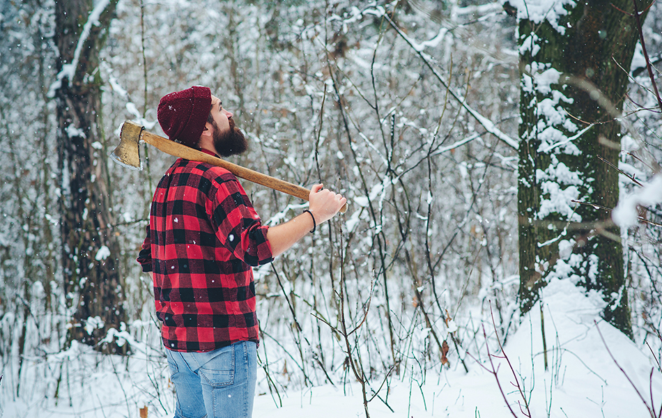 lumberjack in winter snowy forest