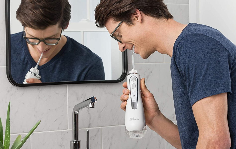 man with water flosser faq
