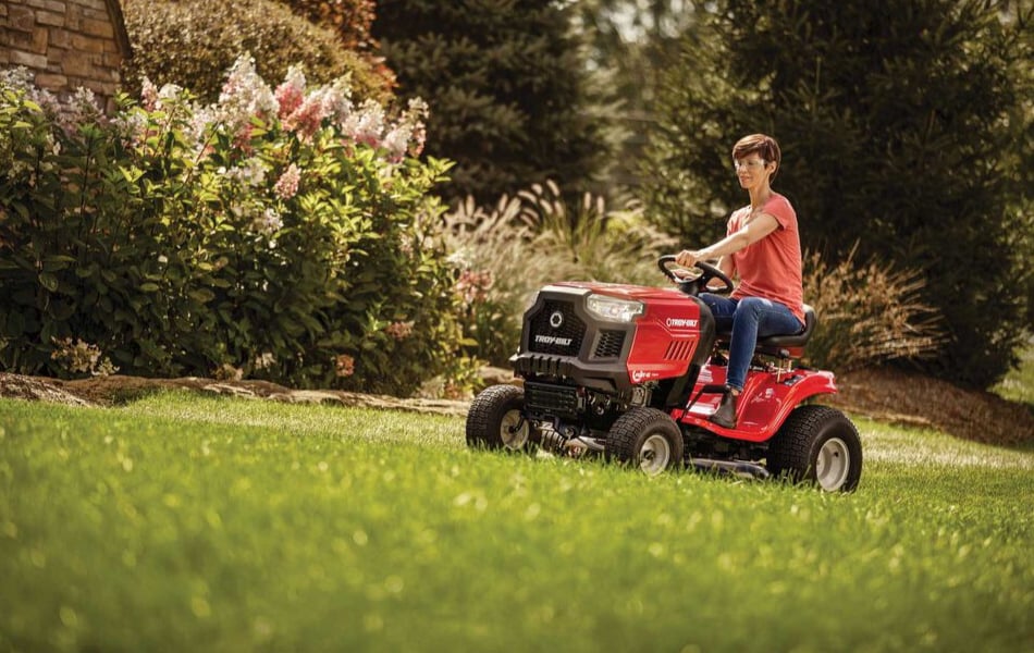 woman riding lawn mower