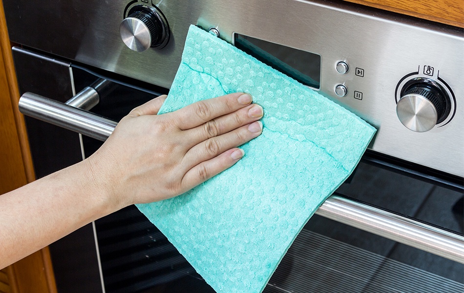 woman hand cleaning oven