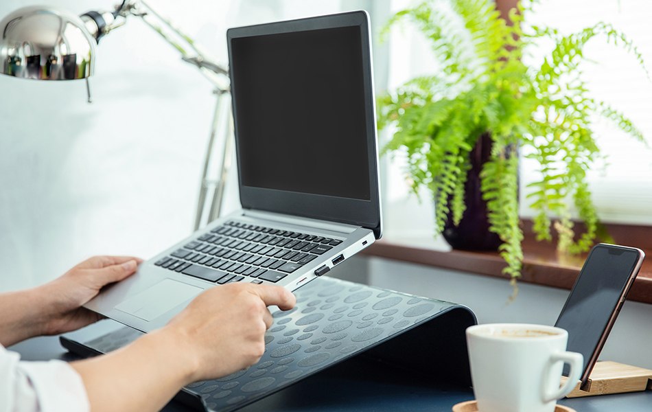 woman puts her ultrabook to laptop's stand