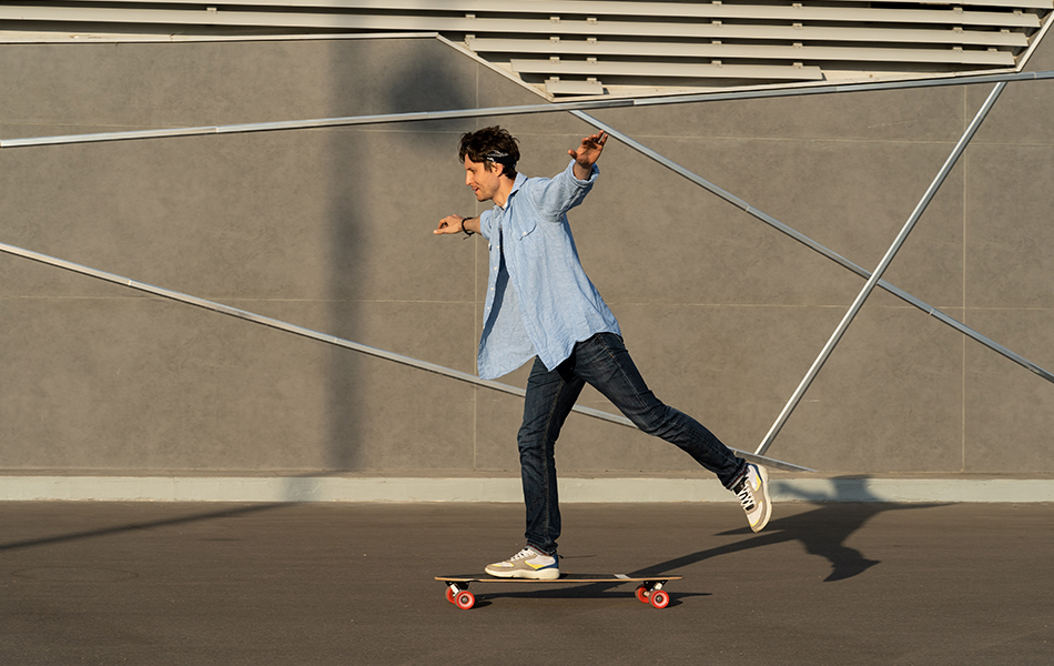 man riding longboard