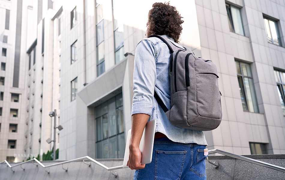 student wearing college backpack