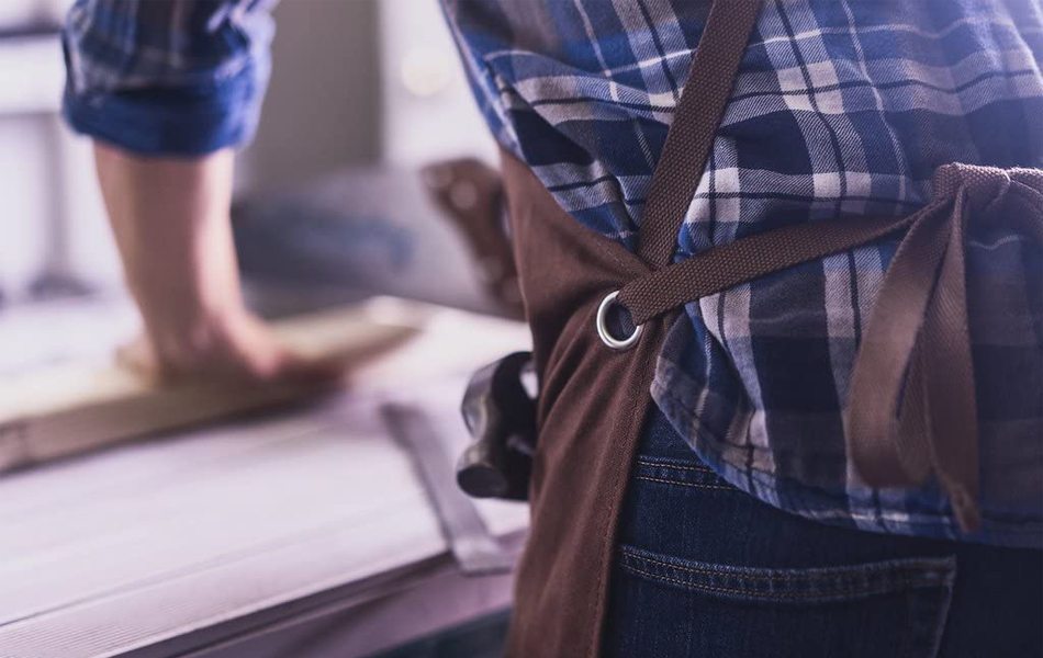 man in apron working in a shop