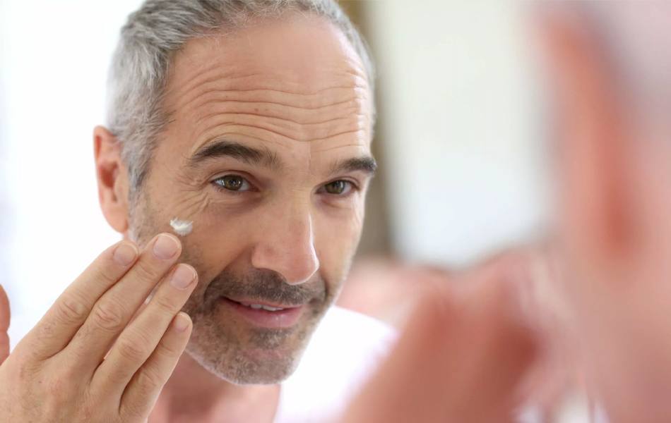 man using face cream