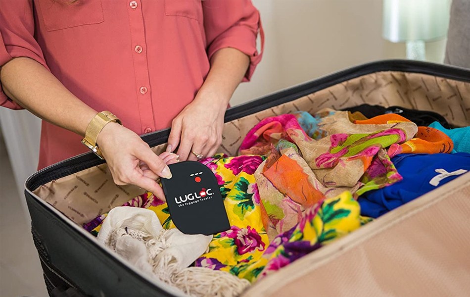 woman placing tracker in a travel bag