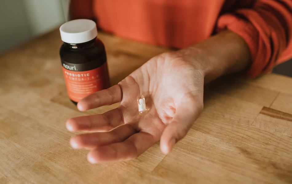 man holding probiotic pill in the hand