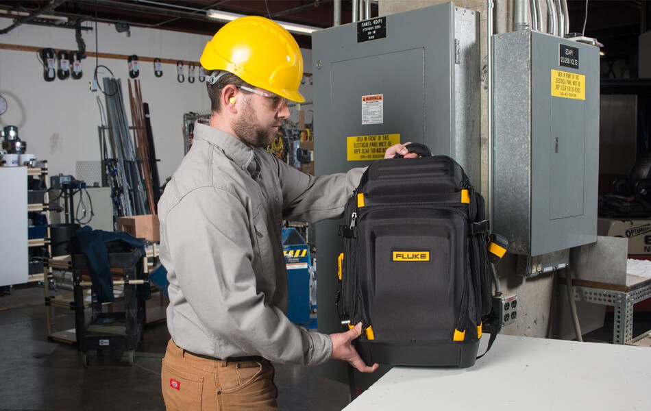 man holding tool backpack