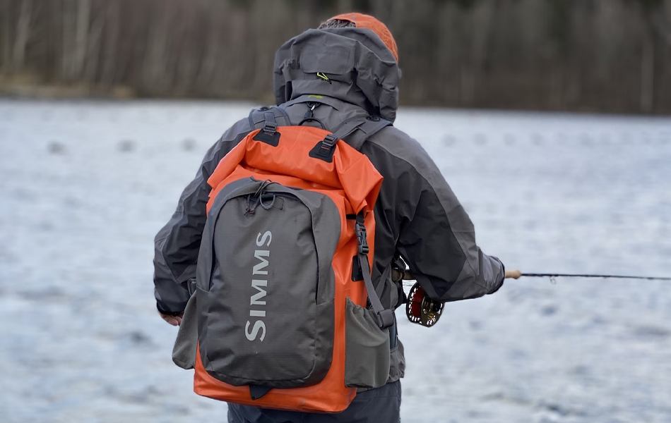 man wearing backpack while fishing