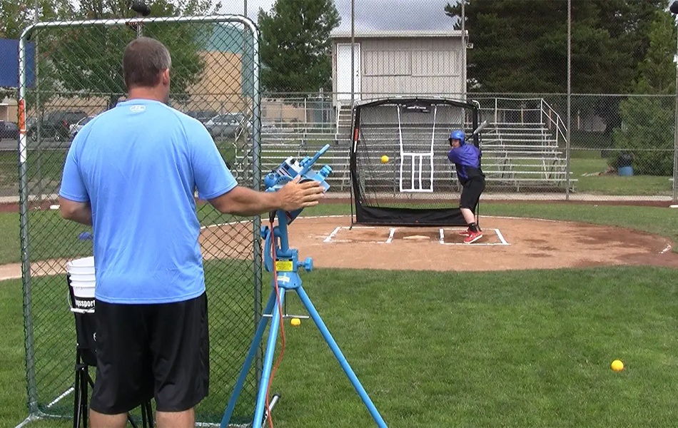 playing baseball using pitching machine