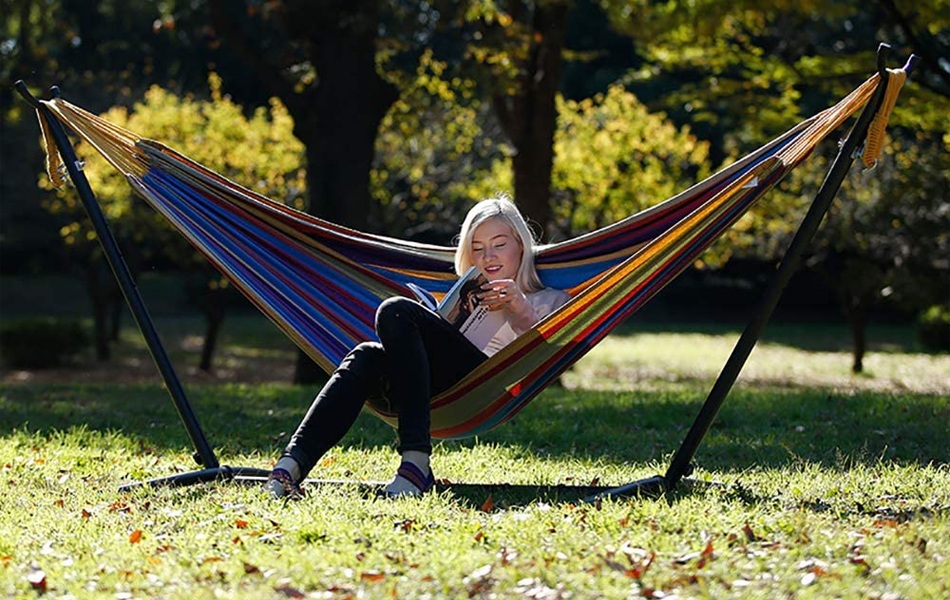 woman reading book in the hammock