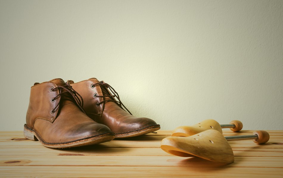 boots and shoe stretcher on the wooden table