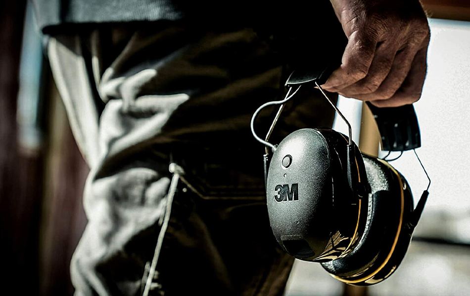 man holding hearing protectors