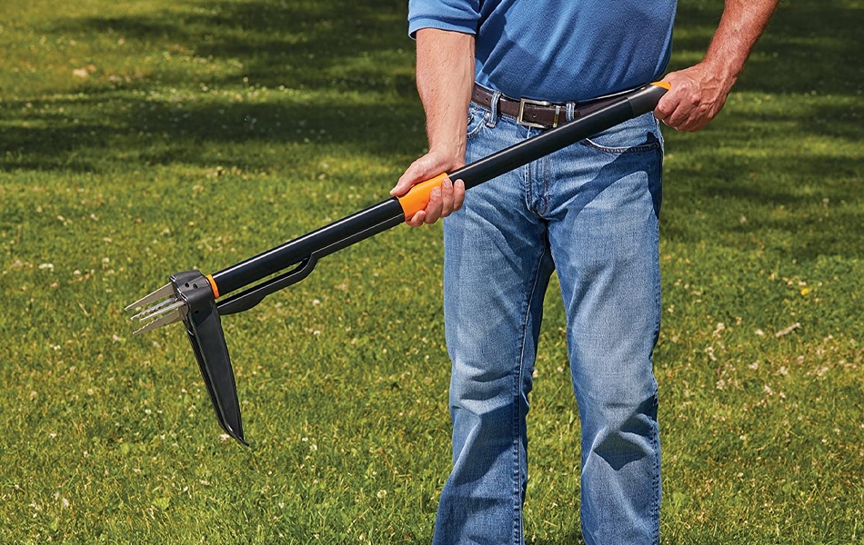 man holding weeding tool
