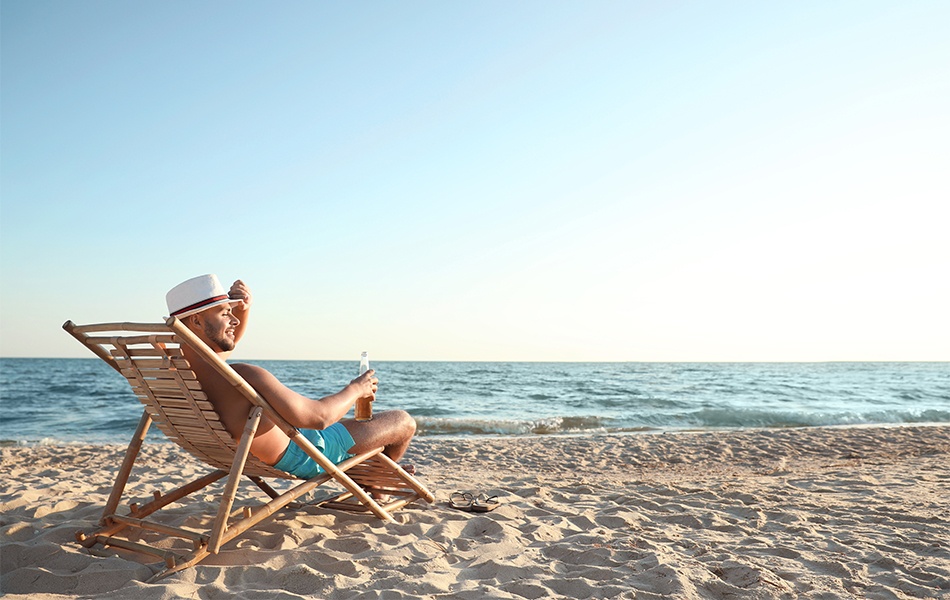 man relaxing in beach chair