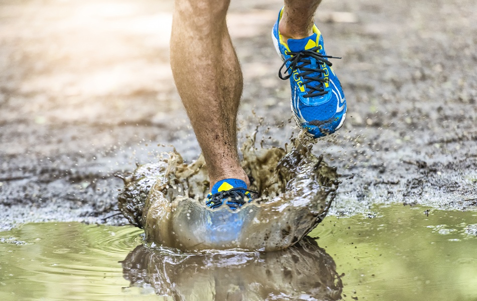 man running on the rain in the waterproof running shoes