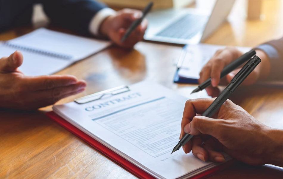 man signing contract with calligraphy pen