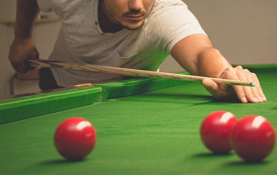 man using pool cue