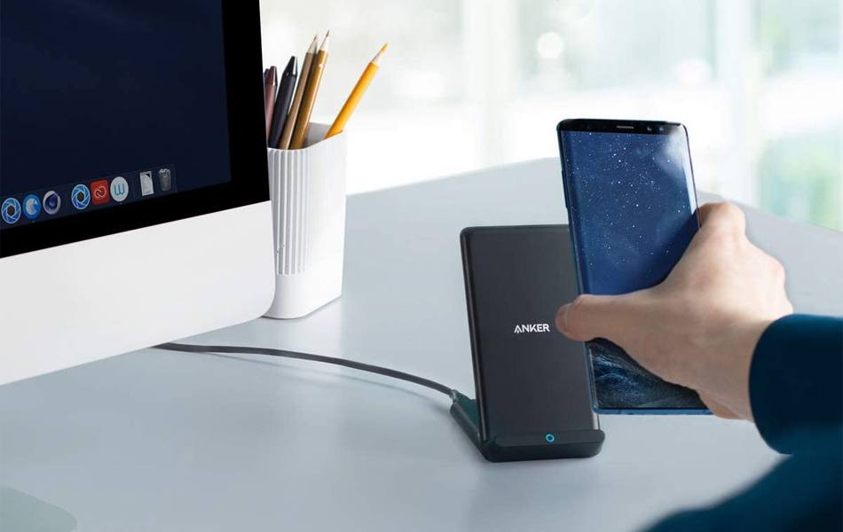 man using wireless charger to charge his phone