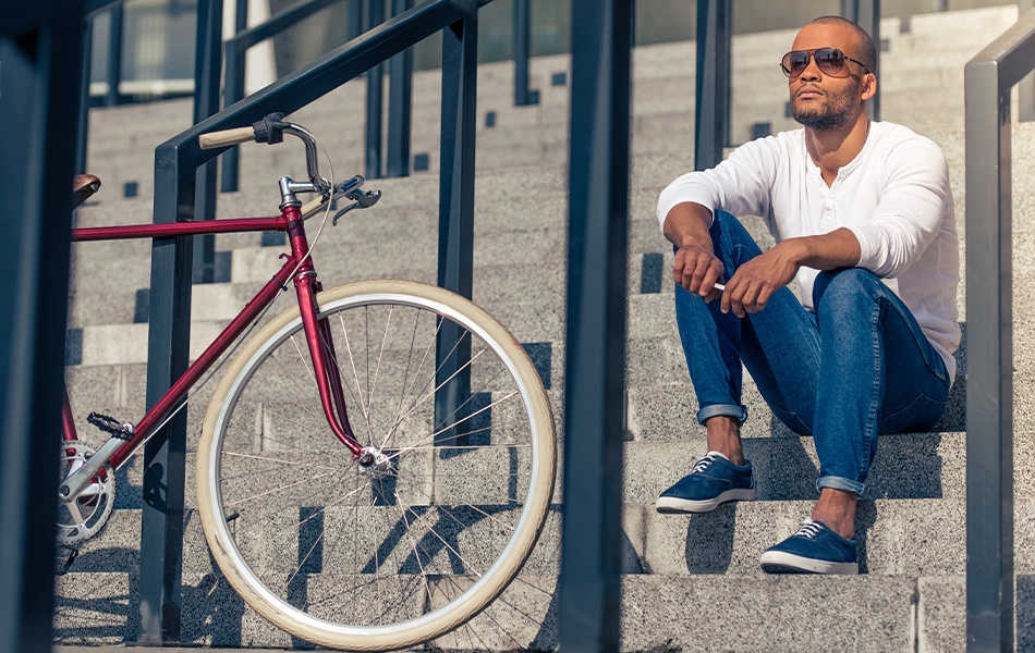 man wearing american made jeans sitting on the stairs