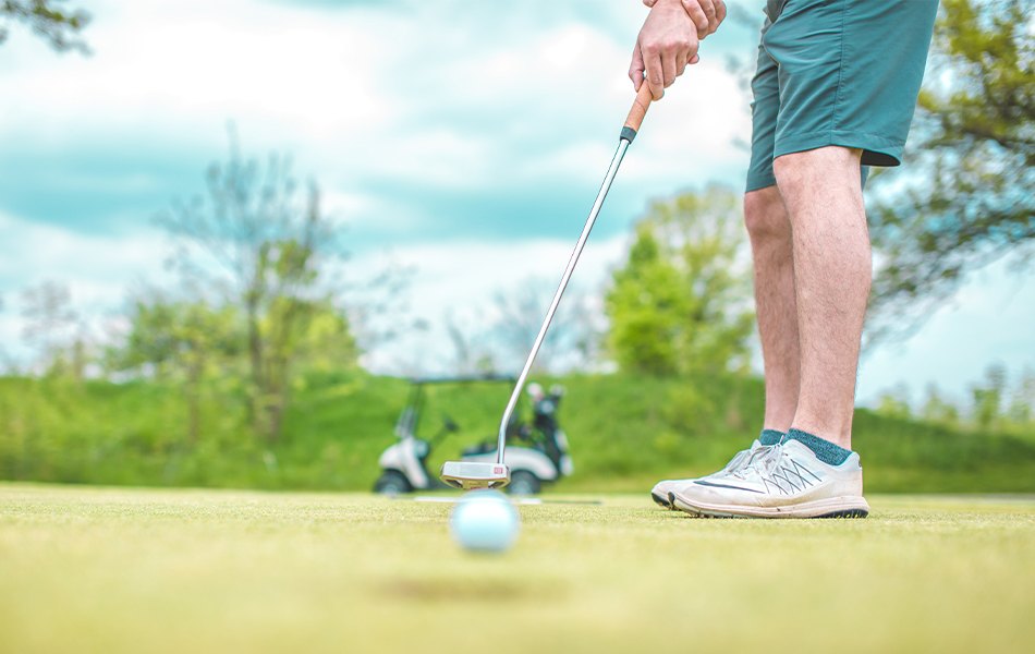 man wearing spikeless golf shoes