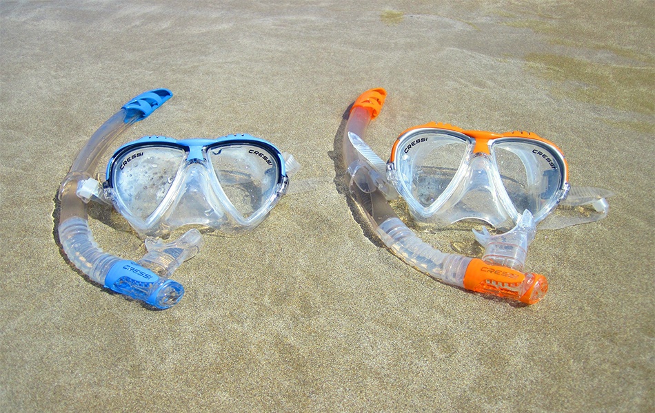 two snorkels on the beach sand