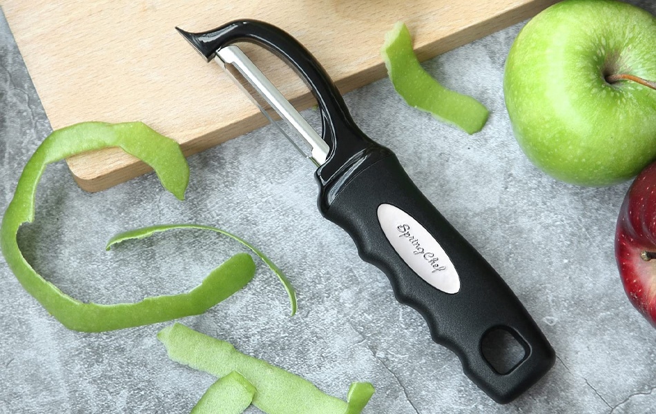 vegetable peeler on the cutting board
