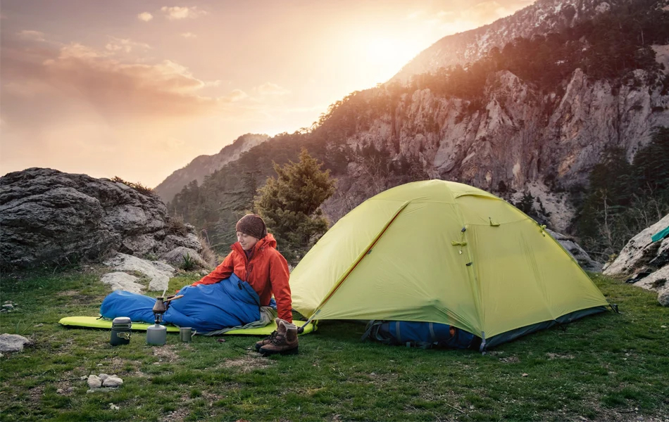 woman in wearable sleeping bag by the camp site