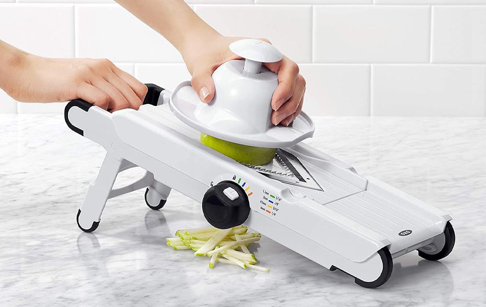 woman using mandoline slicer