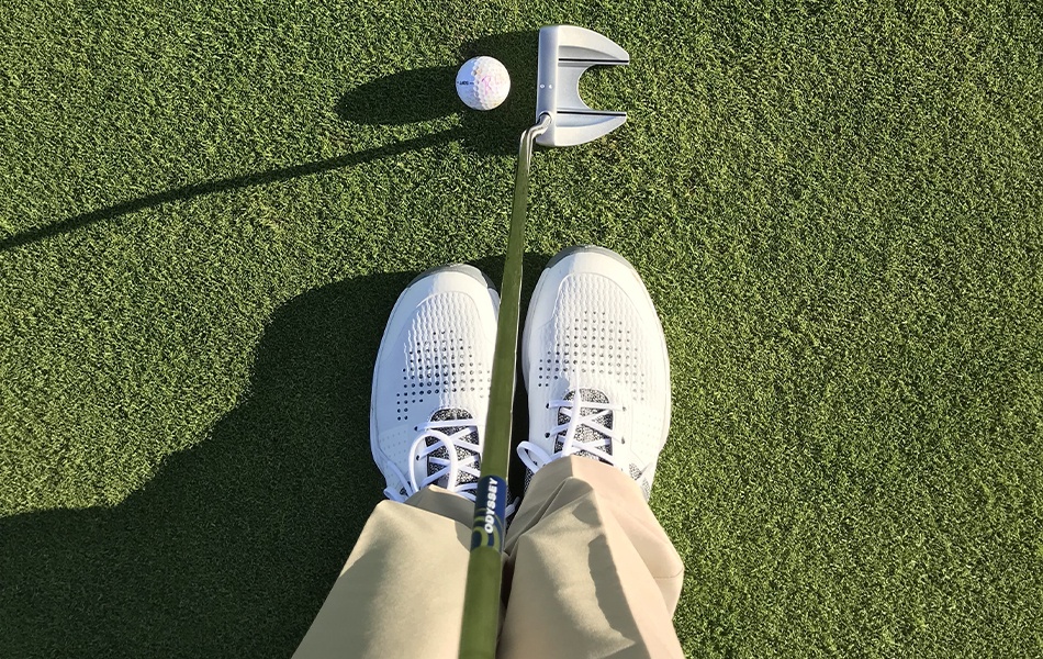 woman wearing spikeless golf shoes