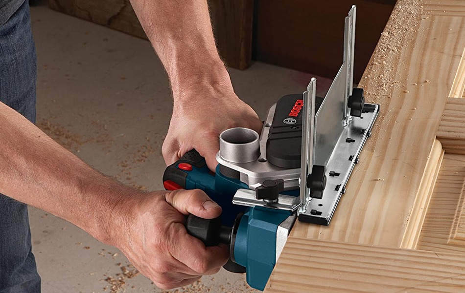 worker using electric hand planer